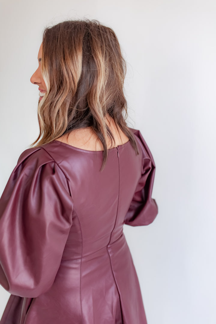 Women’s merlot leather dress with puff sleeve detail and zipper in the back