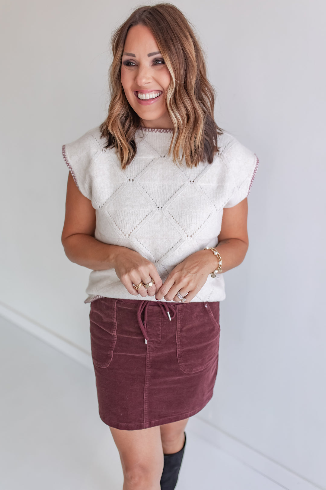 Cream short sleeve sweater with wine stitching and wine corded skirt