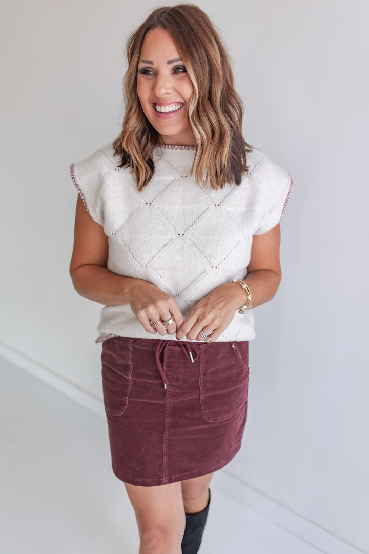 Cream short sleeve sweater with wine stitching and wine corded skirt