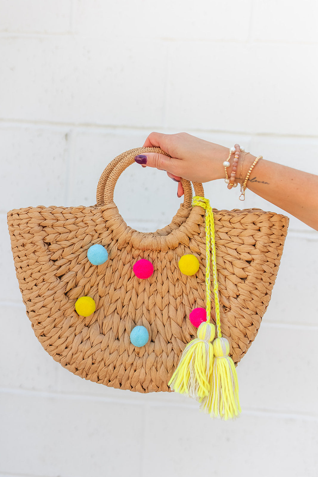 The Woven Straw Pom Bag