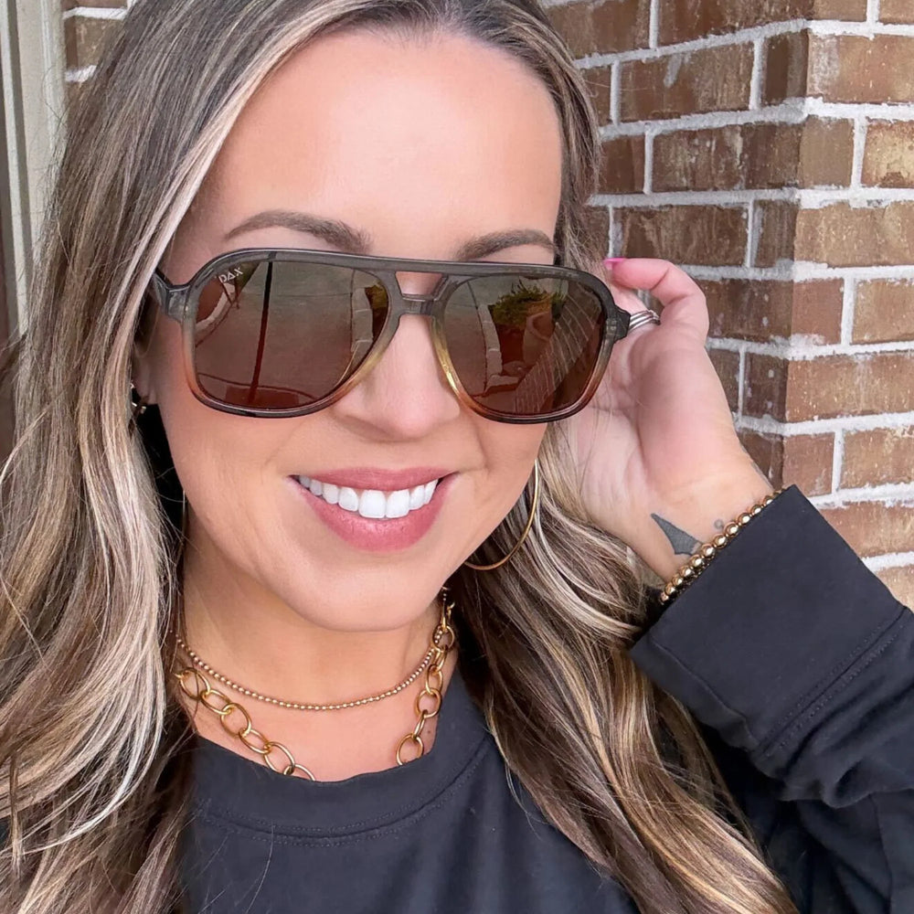 Woman wearing Cruz grey, polarized sunglasses
