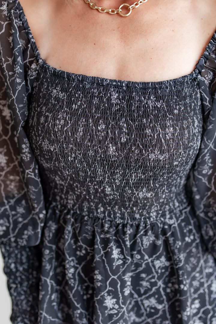 close up of smock chest on a long black floral dress styled for family photos