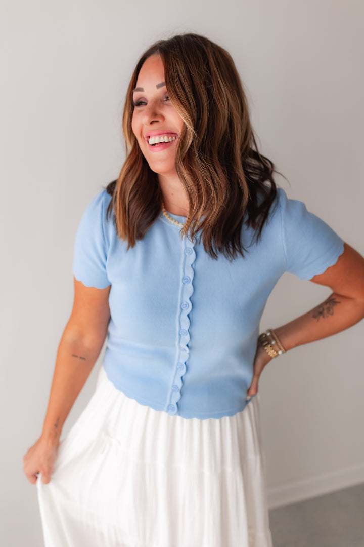 A light blue scallop trim button front boutique top styled with white maxi skirt.