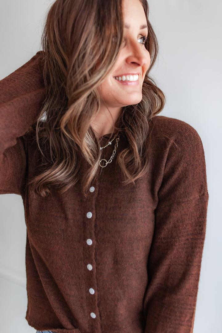 Model wearing brown button-up knit cardigan