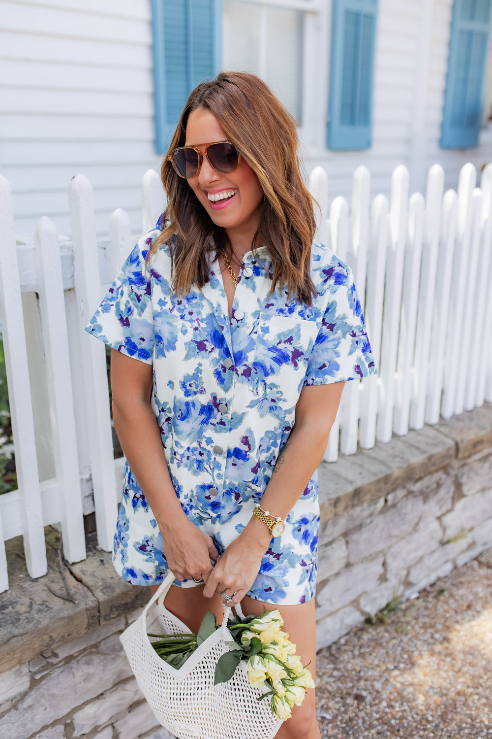 Floral denim romper for women styled as a casual summer outfit with sandals