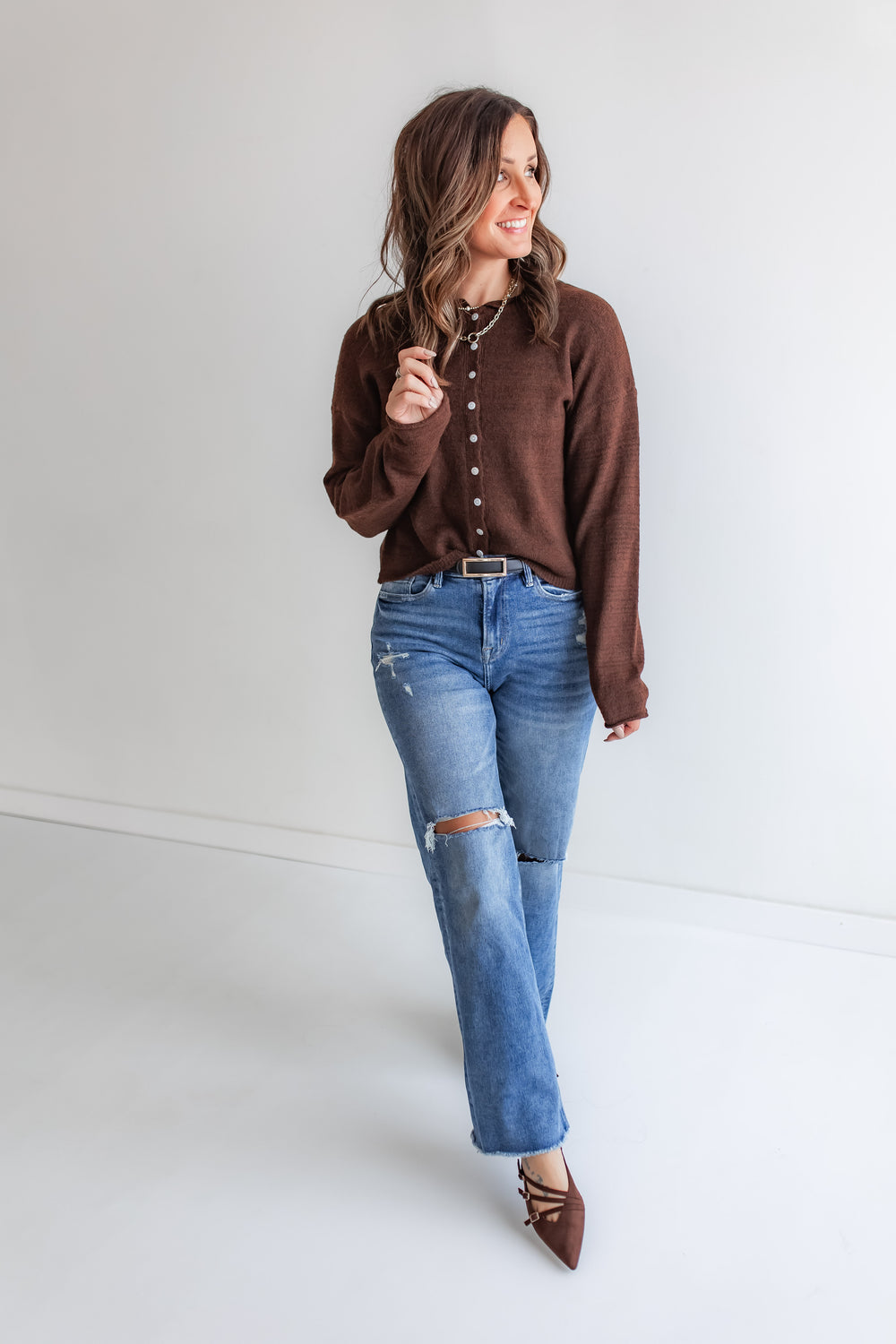 Chocolate brown sweater button cardigan paired with medium wash mica denim