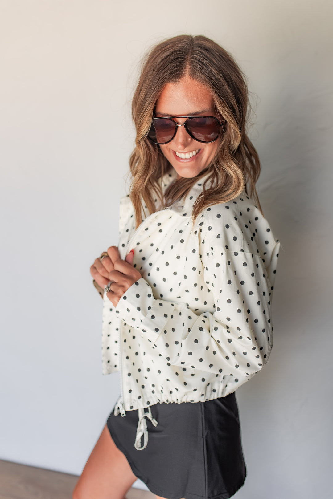Close-up of cream polka dot jacket zipper and collar detail