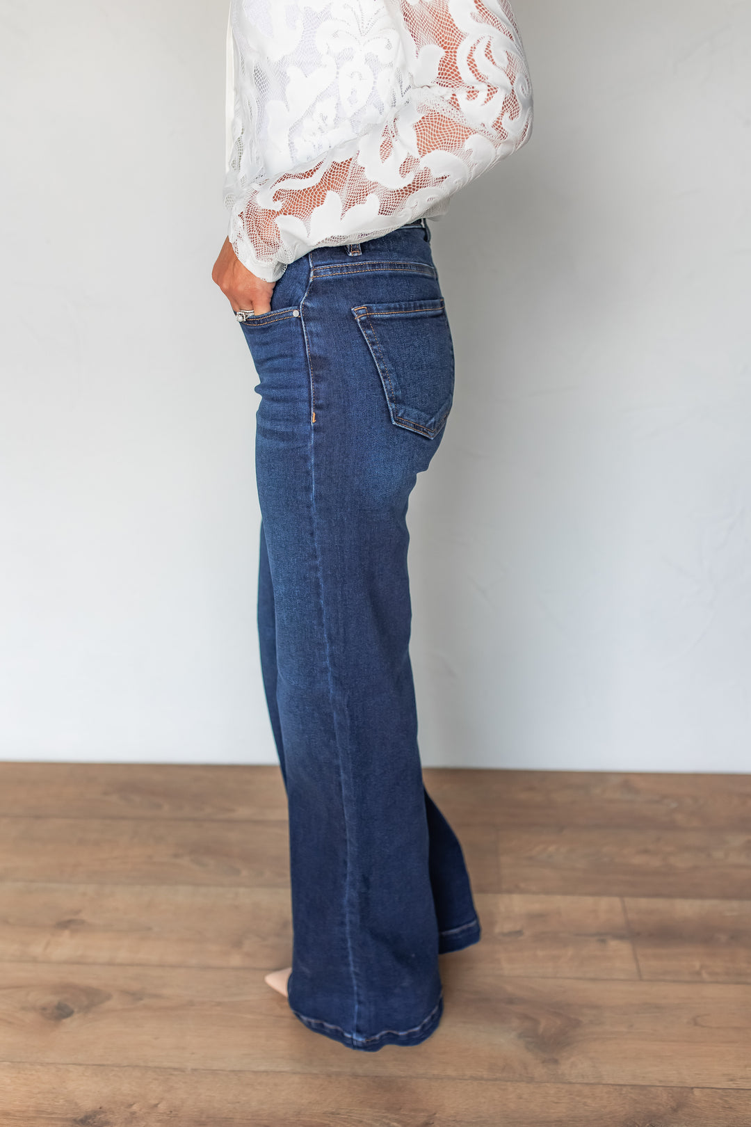 Side profile of dark wash wide leg jeans