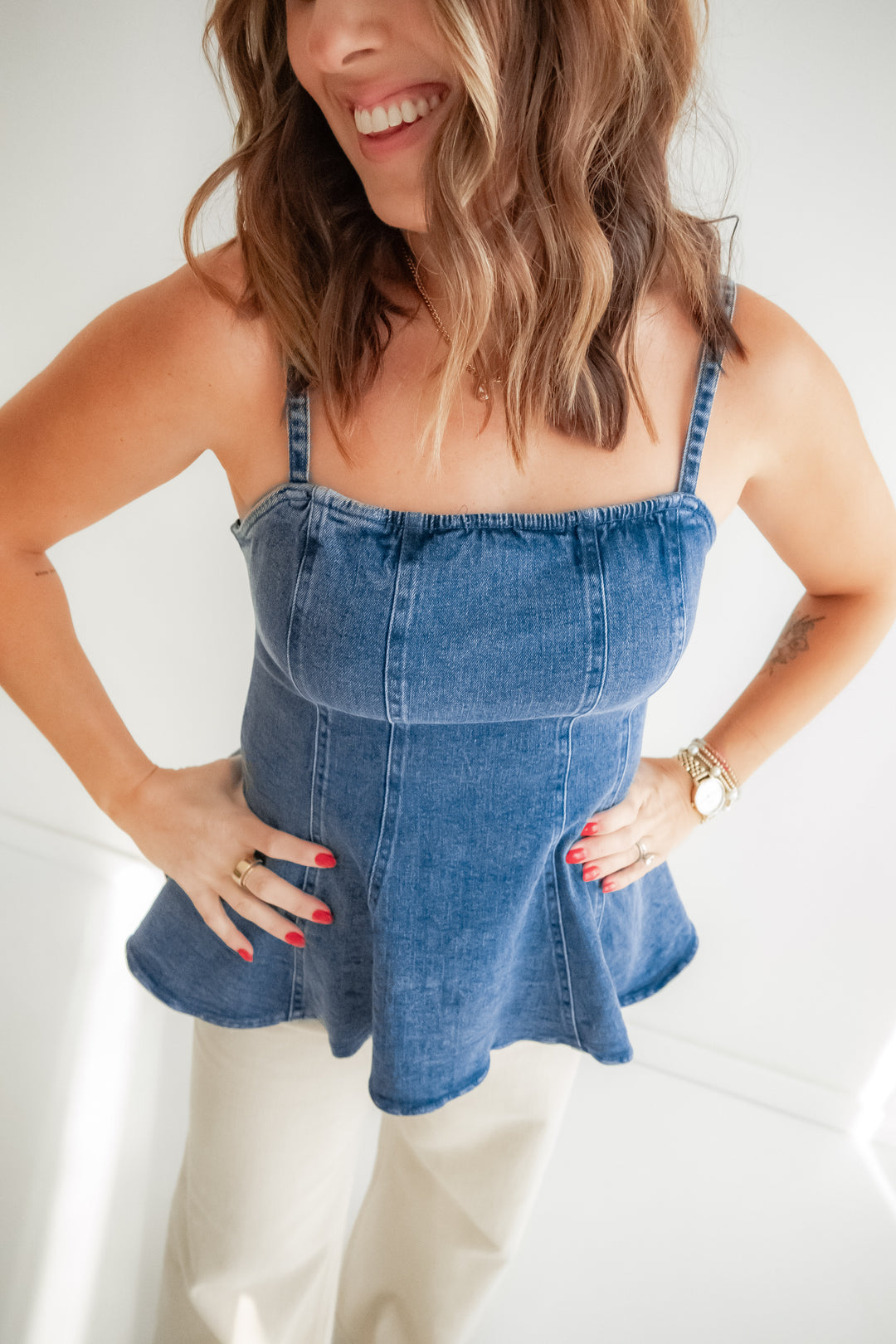 Woman wearing a denim top with a white pants