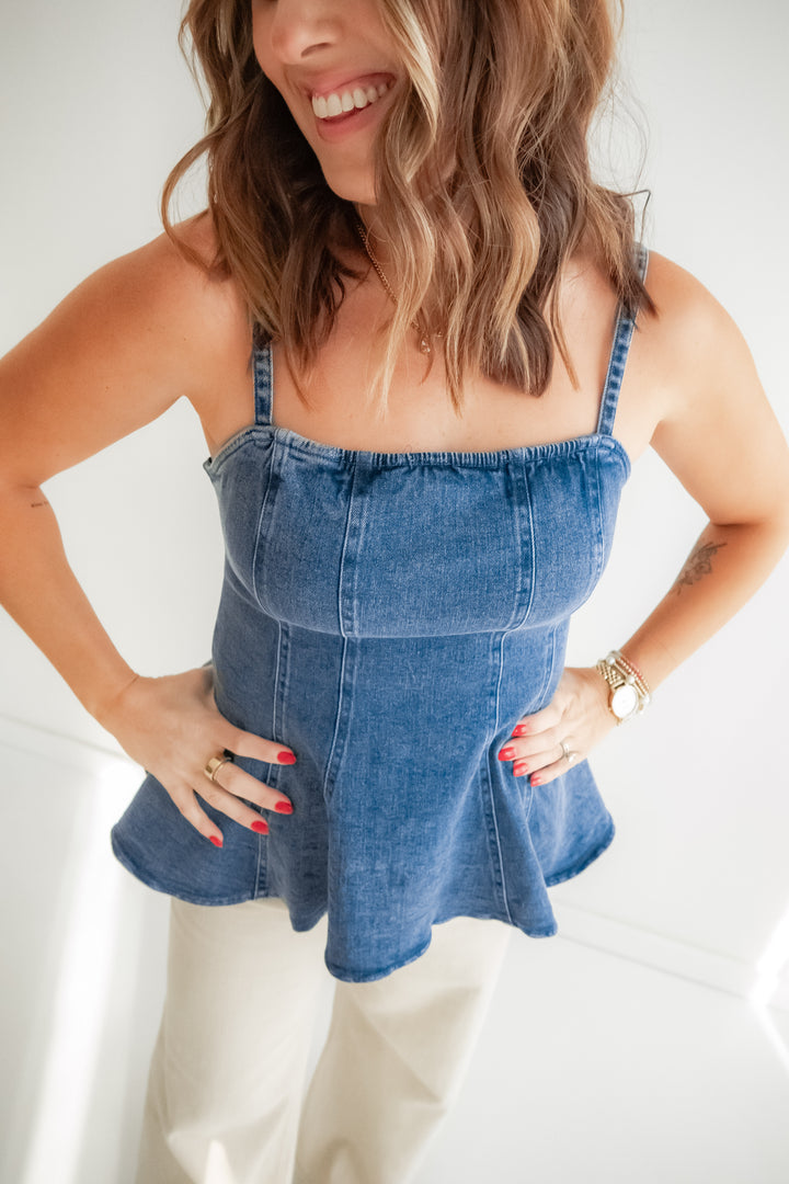 Woman wearing a denim top with a white pants