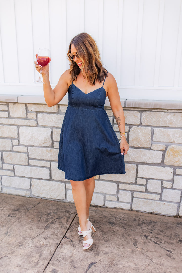 Women’s sleeveless denim dress styled for a casual summer outfit