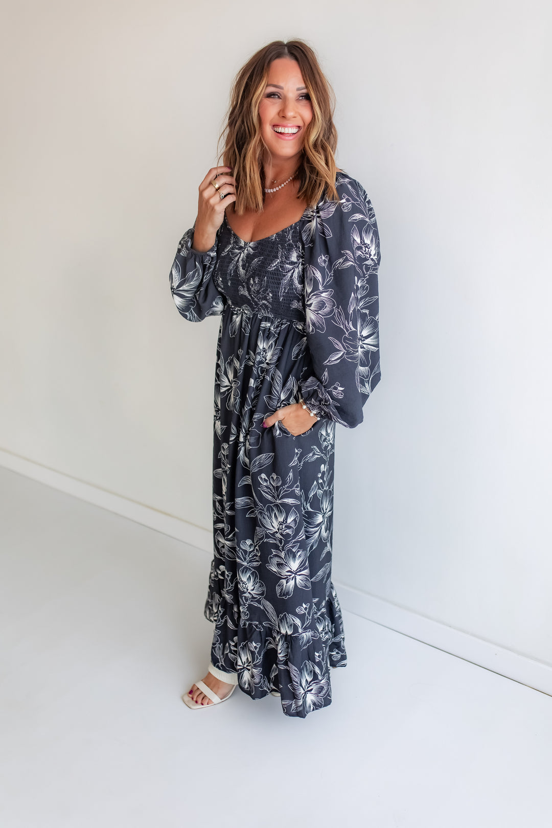 Woman wearing a floral dress against a white background