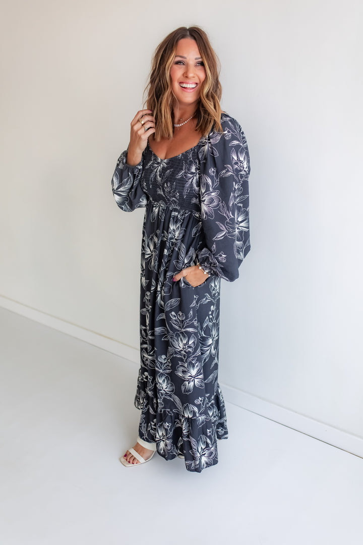 Woman wearing a floral dress against a white background