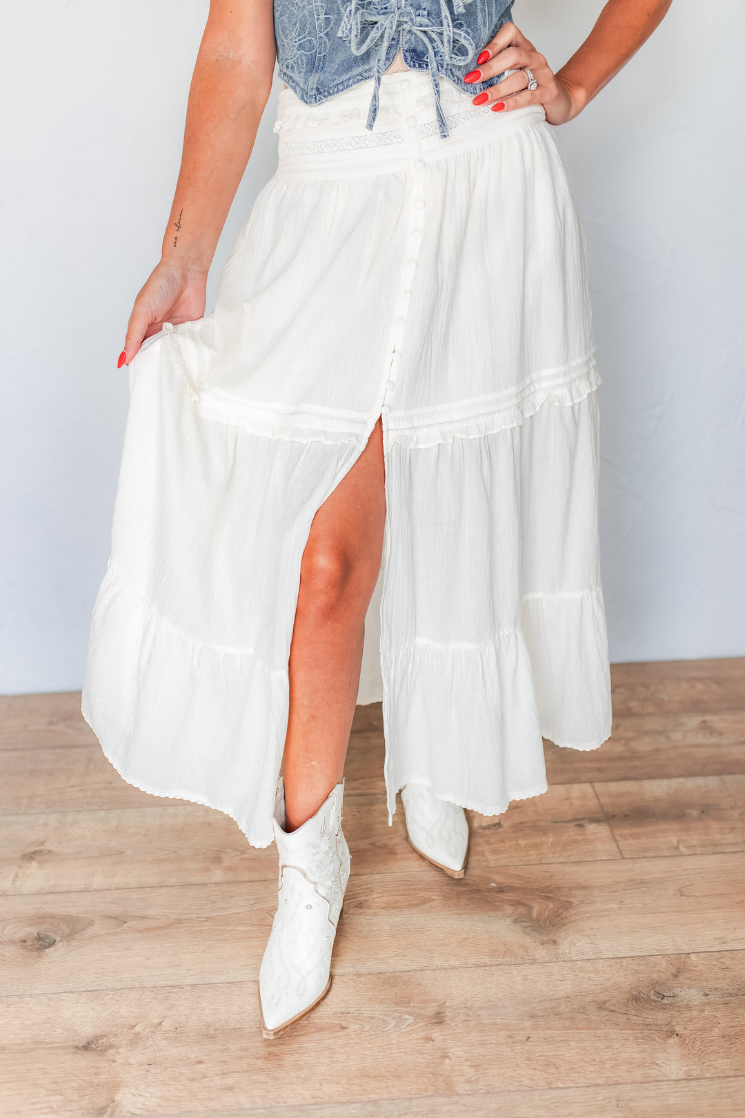 Ivory tiered maxi skirt front slit detail with white western boots