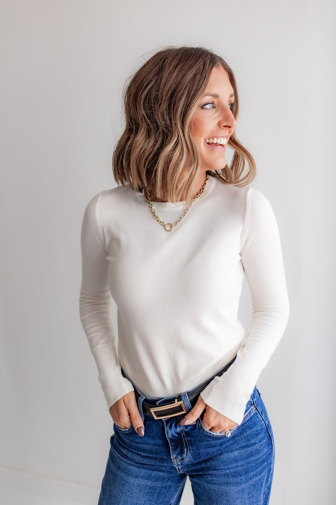 Ivory long sleeve top with gold cuff buttons