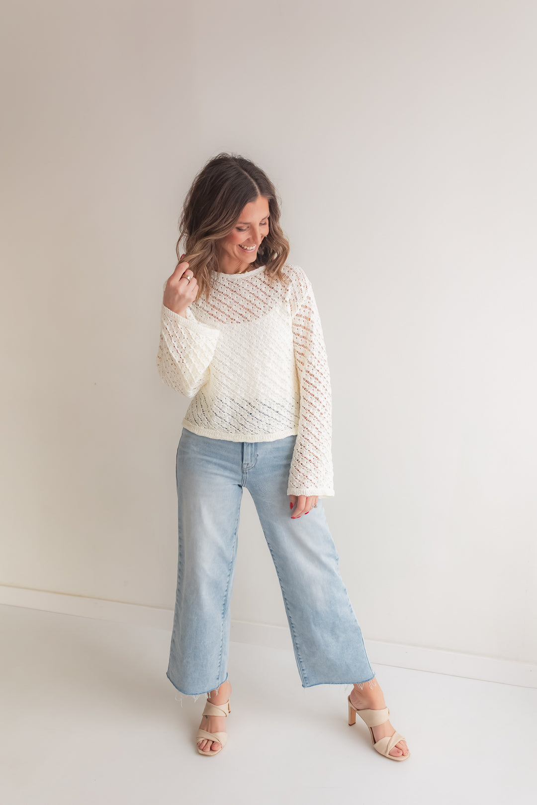 Ivory breathable open knit sweater paired with denim jeans for an everyday warm weather outfit