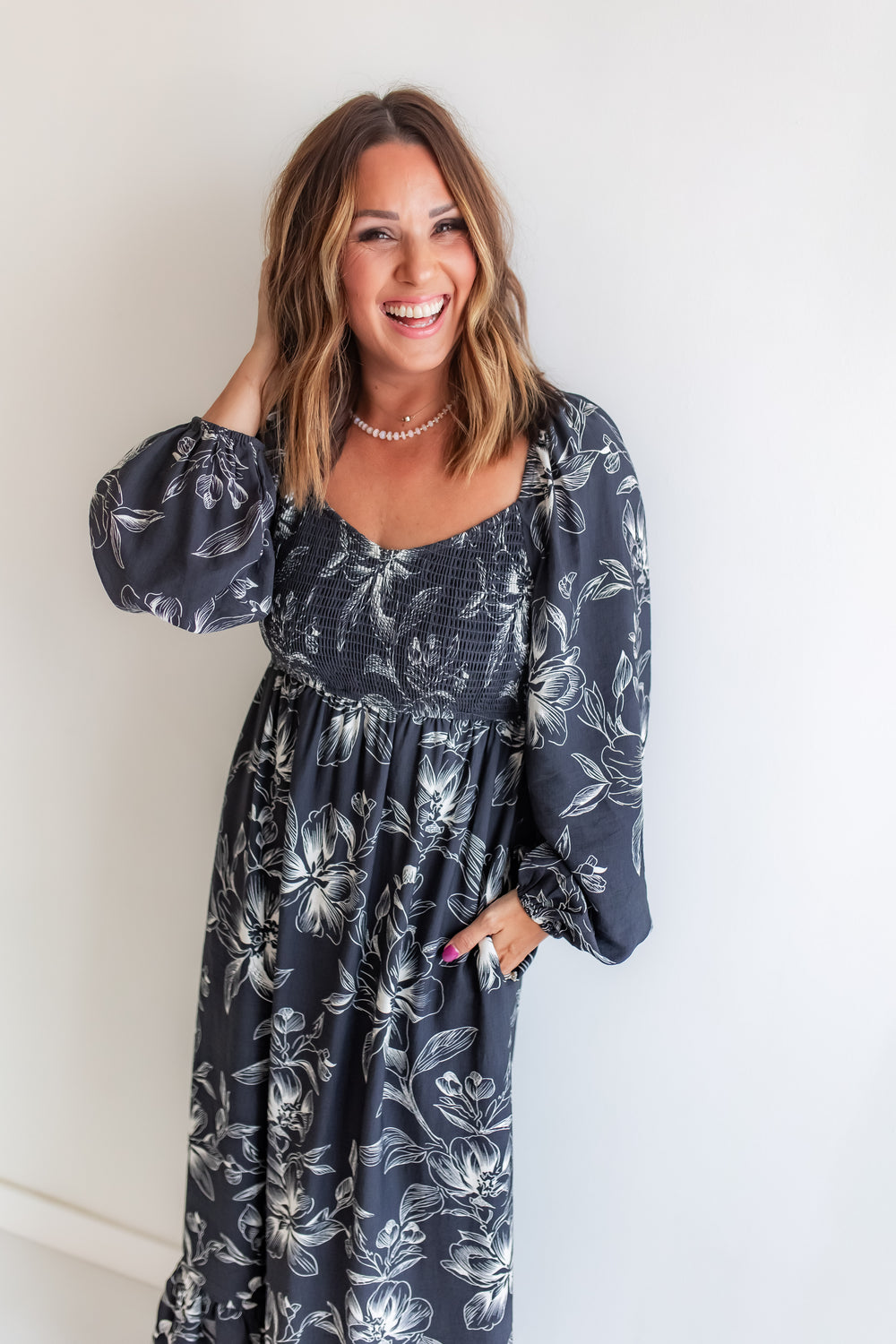 Woman wearing a Charcoal and ivory floral maxi dress with long sleeves