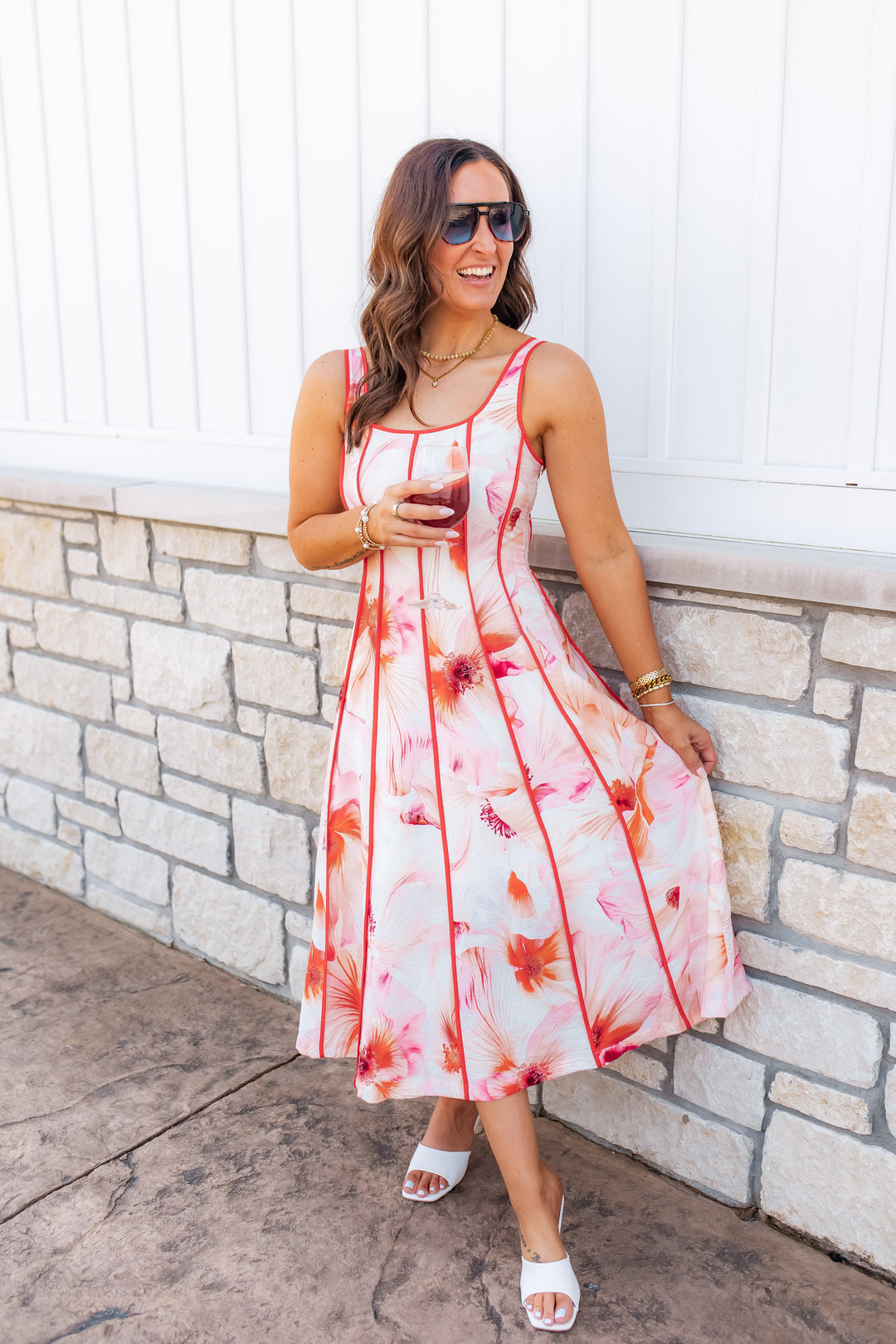 Pink and orange floral midi dress styled for a summer event or date night