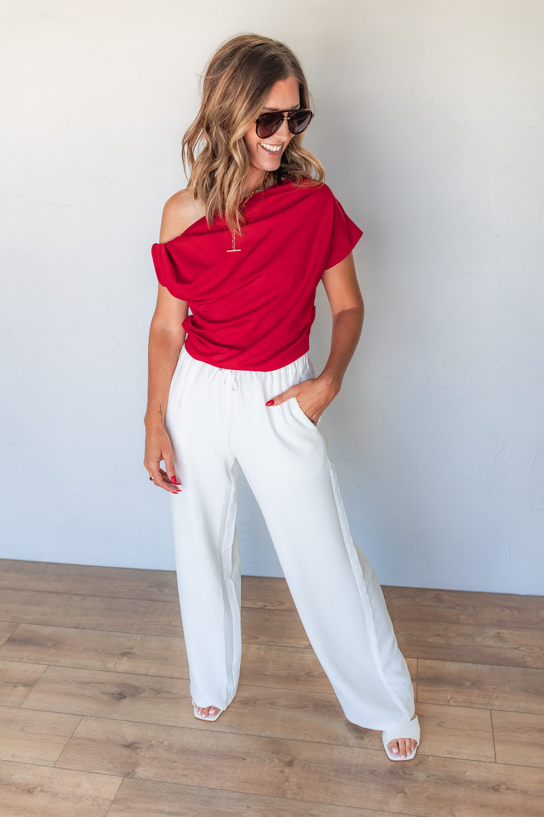 Red one shoulder top with draped detail for women