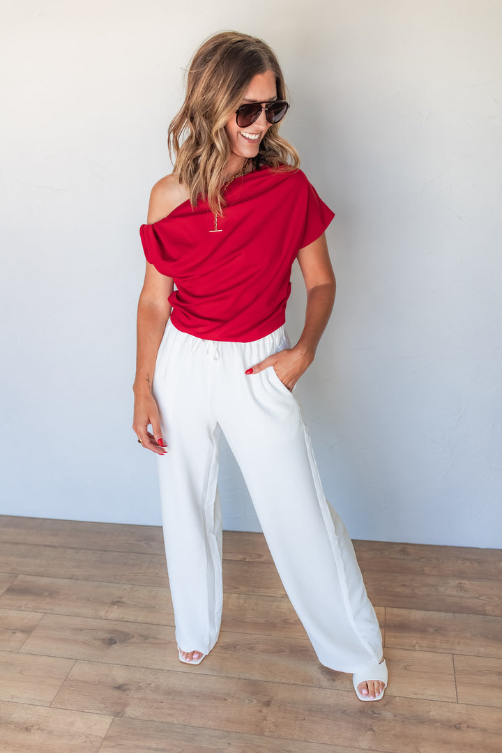 Red one shoulder top with draped detail for women