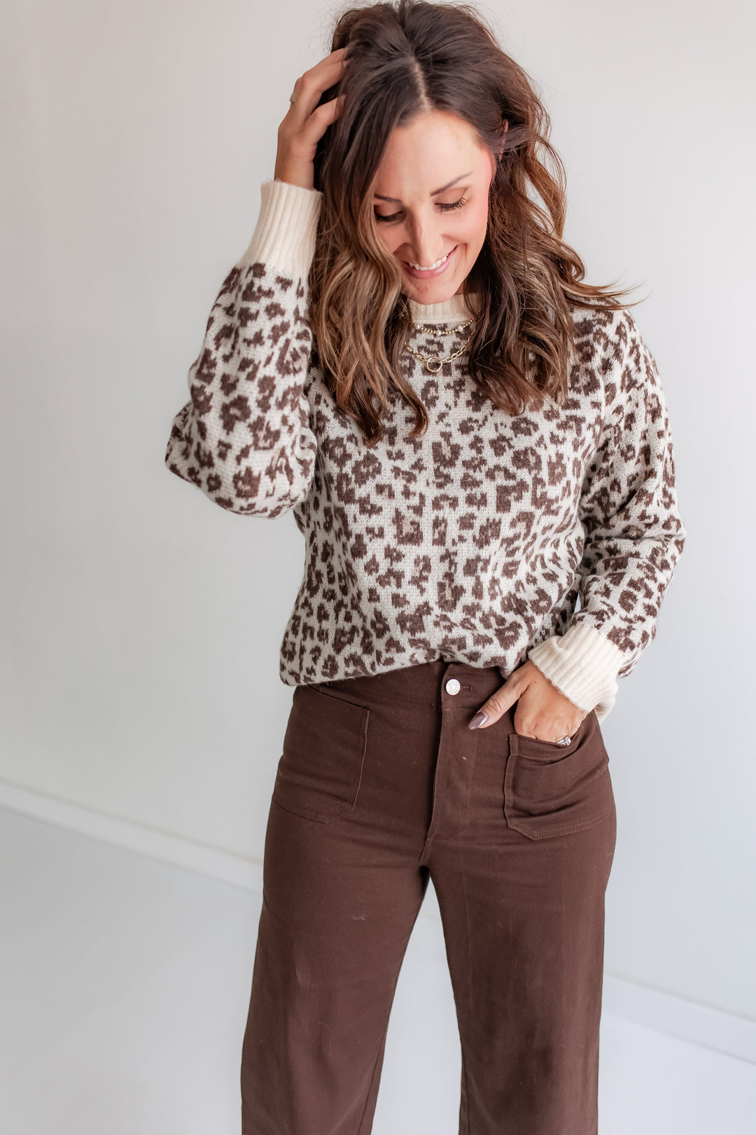 Model wearing cozy leopard sweater, animal print knit