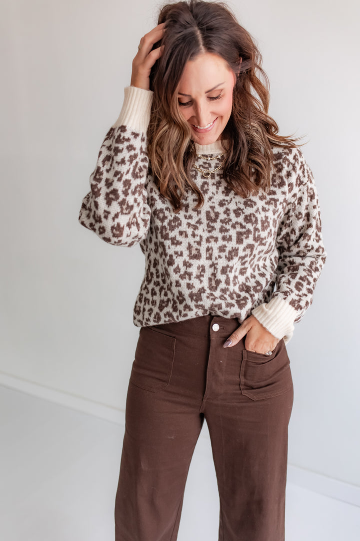 Model wearing cozy leopard sweater, animal print knit