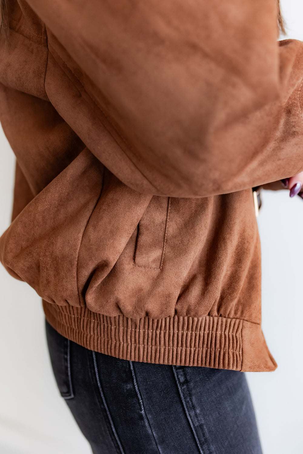 Suede bomber layered over neutral outfit
