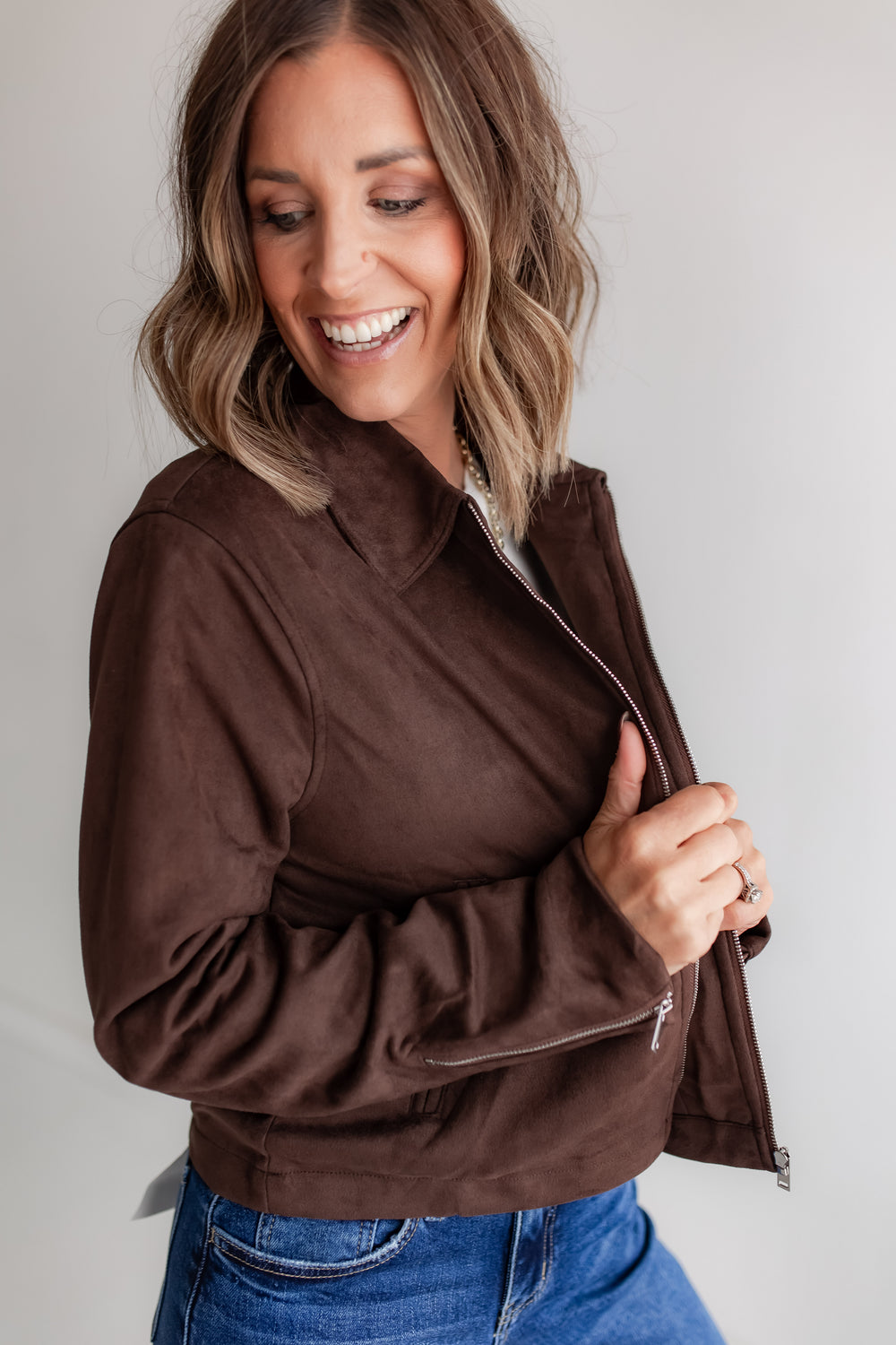 close up of brown suede jacket on a woman