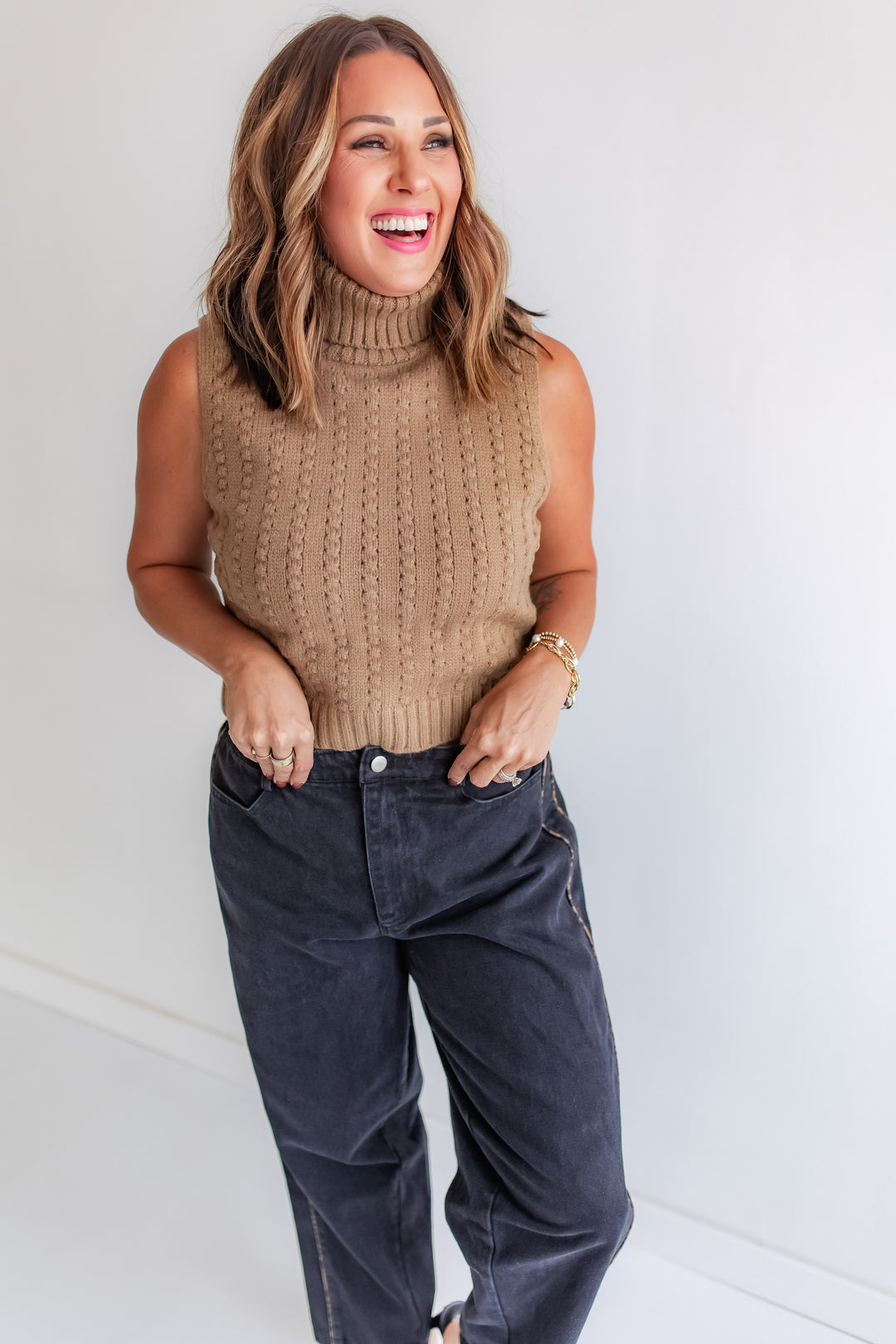 Model wearing toffee sleeveless turtleneck sweater