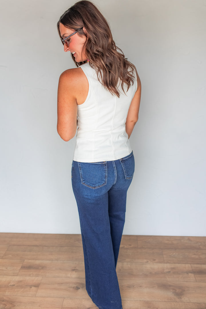Back view of white denim vest showing fitted silhouette