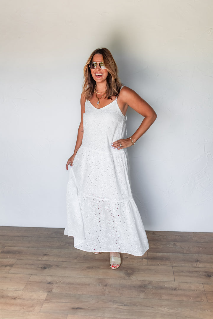 Woman wearing white eyelet tiered maxi dress with sandals