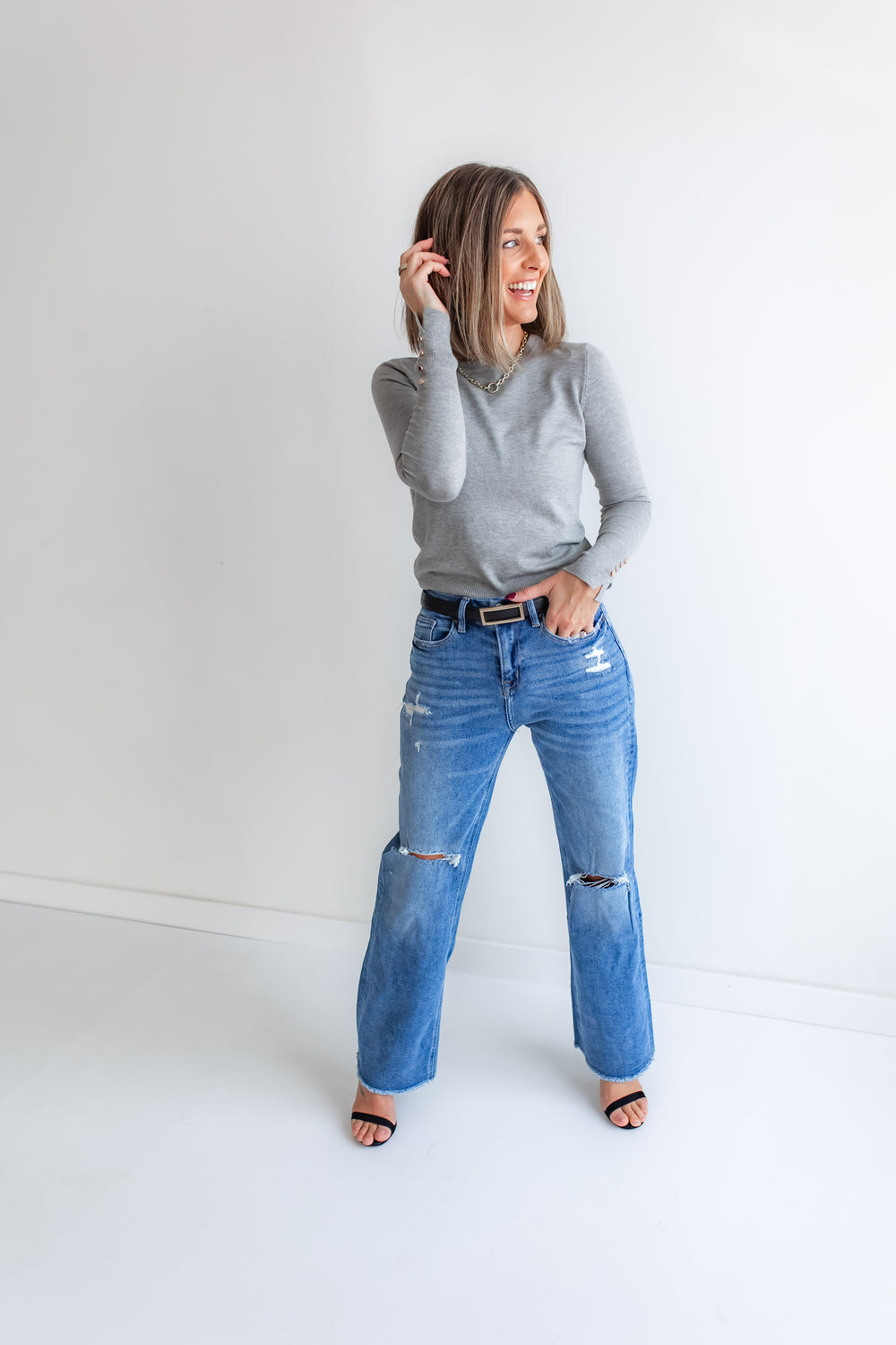 Model wearing a pair of Mica dark wash wide leg denim jeans.