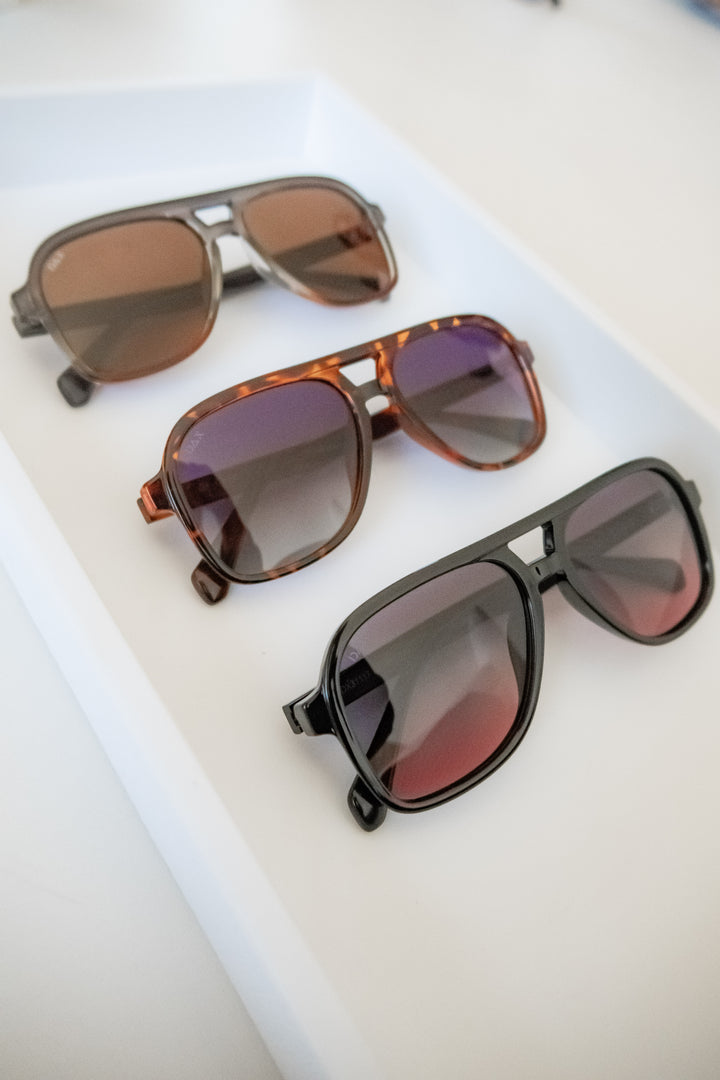 Three pairs of Cruz lightweight sunglasses on a white surface
