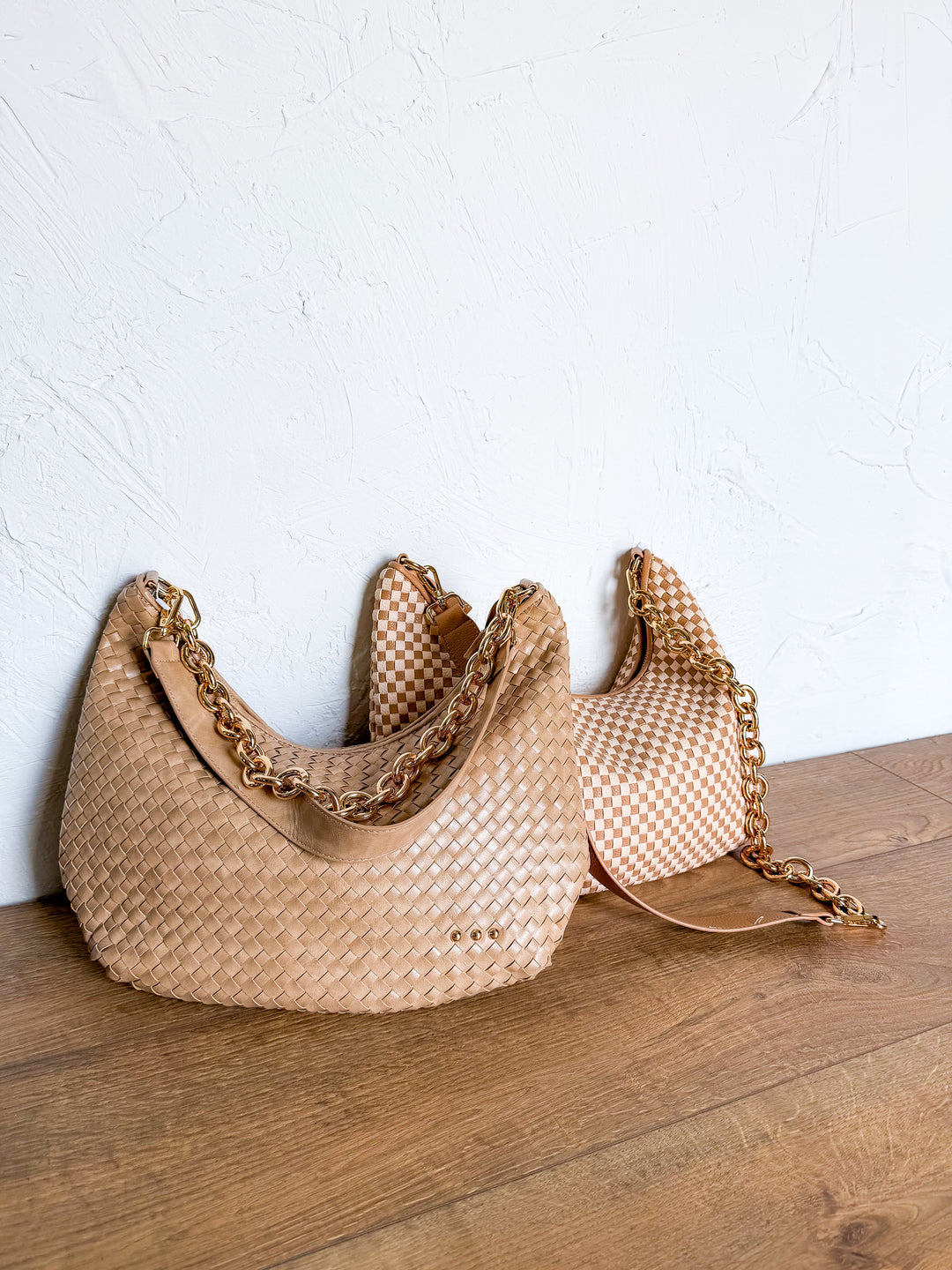 Woven crescent shoulder bags with gold chain straps in tan, checkerboard, and chocolate brown