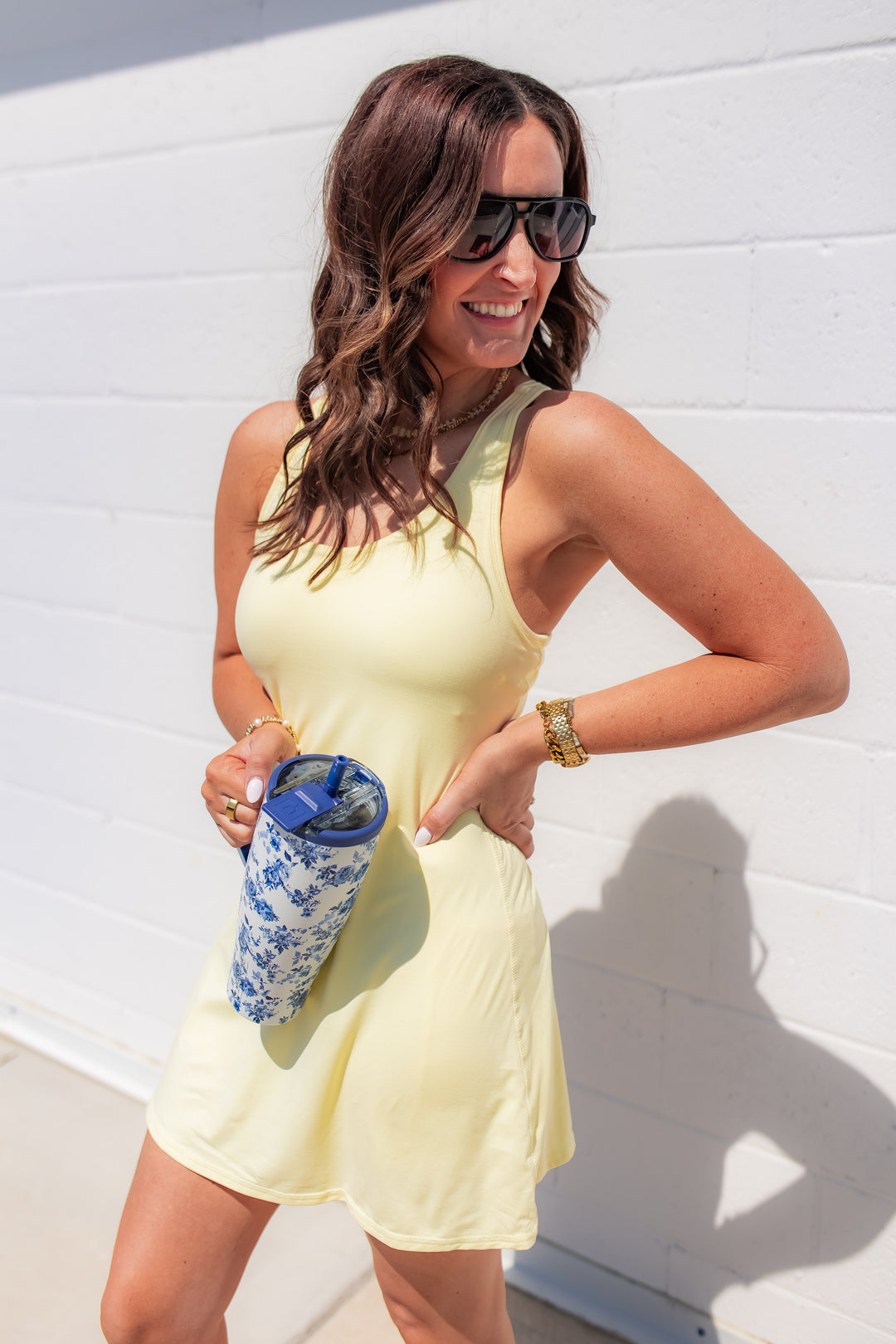 Yellow active dress with built-in shorts and bra styled for a casual sporty outfit